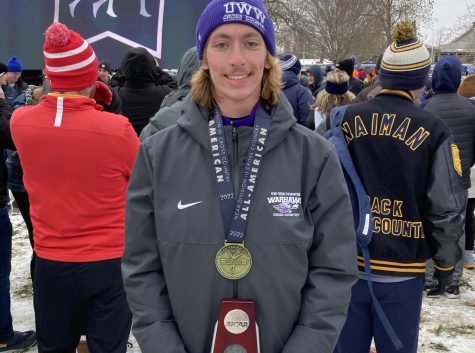Christian Patzka poses with his second place medal and trophy as he became an All-America for the second time in Lansing, Michigan on Saturday Nov. 19.
