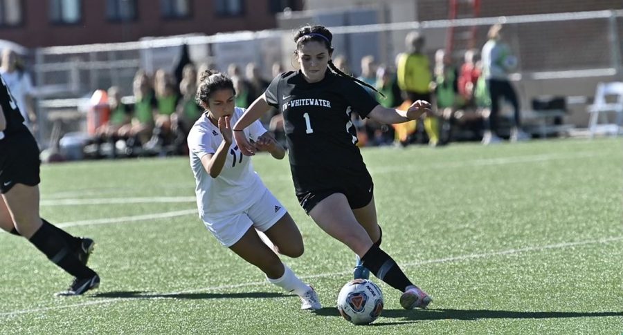 Sarah Clancy competes against a defender for the ball during a D3 soccer match