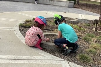 Photo of the children playing outside of the Roseman building; photo taken from Childrens Center website. 