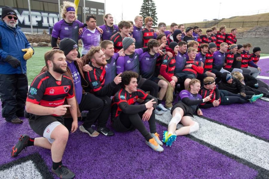 Ruby clubs from UW-Whitewater and UW-Stevens Point pose for a photo in an end zone at Perkins Stadium following their afternoon match on Saturday, March 18, 2023. The Warhawks won the match. (UW-Whitewater Photos/Craig Schreiner)