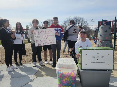 Members of Phi Delta Zeta, Delta Zeta and Congregational UCC pose with the easter eggs and their sign before the big easter egg hunt April 8 2023. (FELICITY KNABENBAUER)