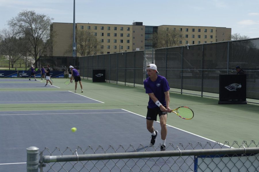 John zakowski goes for a back hand return during his doubles match against Stevens Point on Friday April 14th at Whitewater tennis complex (photo John Hynst)

