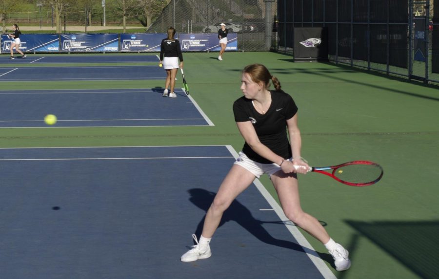 Cassandra Lee goes for a backhand return against Edgewood College on Tuesday April 18th at the Warhawk Outdoor Tennis Complex