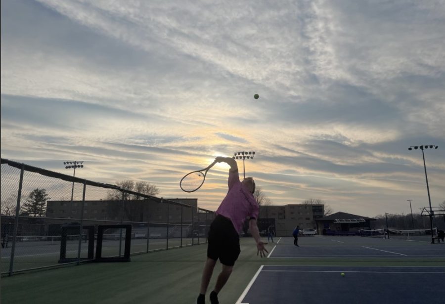 Sophomore Parker Olsen Hits a serve while playing tennis on Thursday April 13th with friends