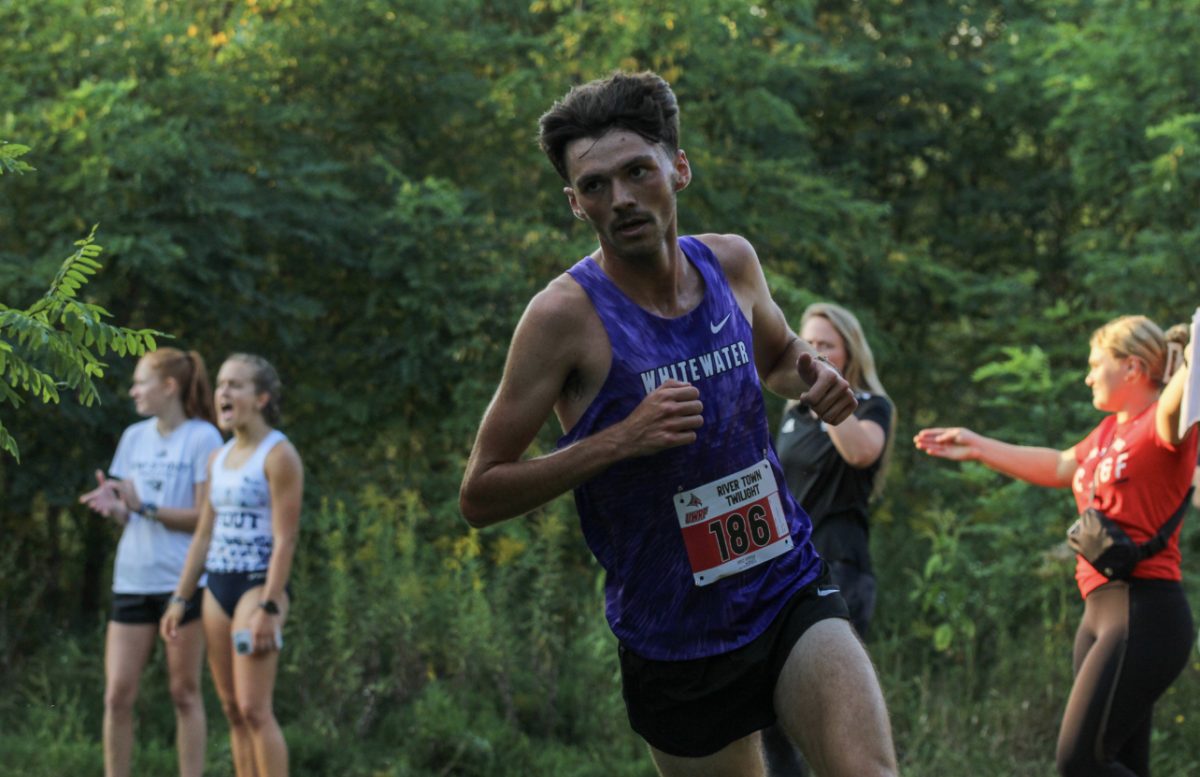 Craig Hundley II runs on his way to a 25:31.4 at the UWRF River Town Twilight