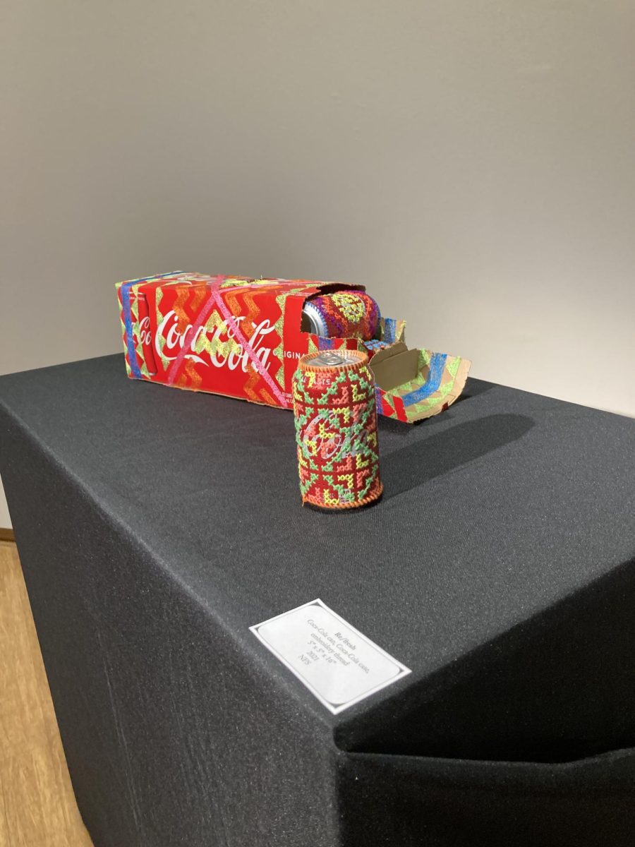 The artist uses modern western materials, seen in the Coke can and box, and interweaves them with cultural patterns