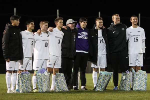 Warhawk seniors pose for senior day with head coach Tony Guinn (five from right).
