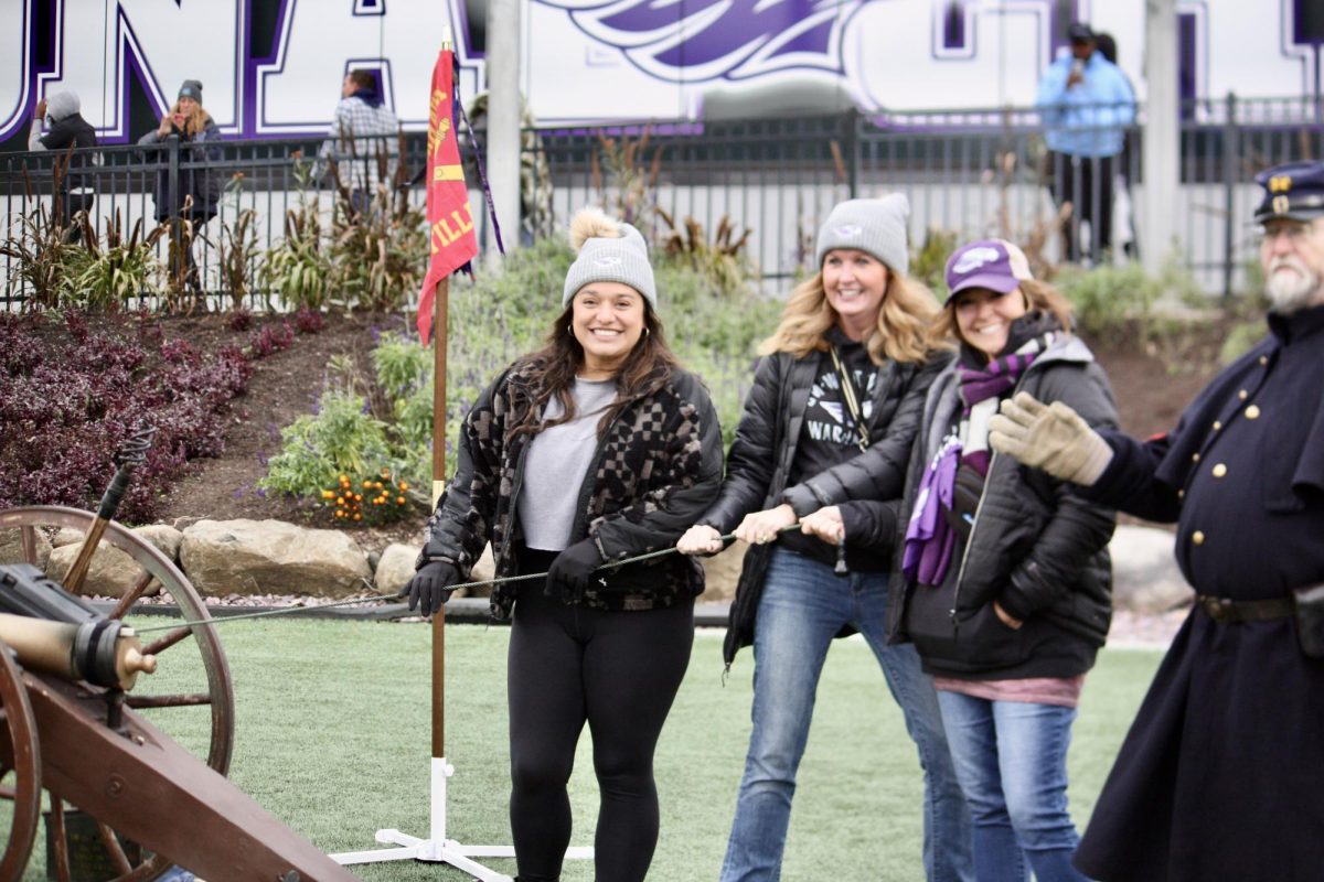 Football moms have fun at the Stout game lighting off the canon