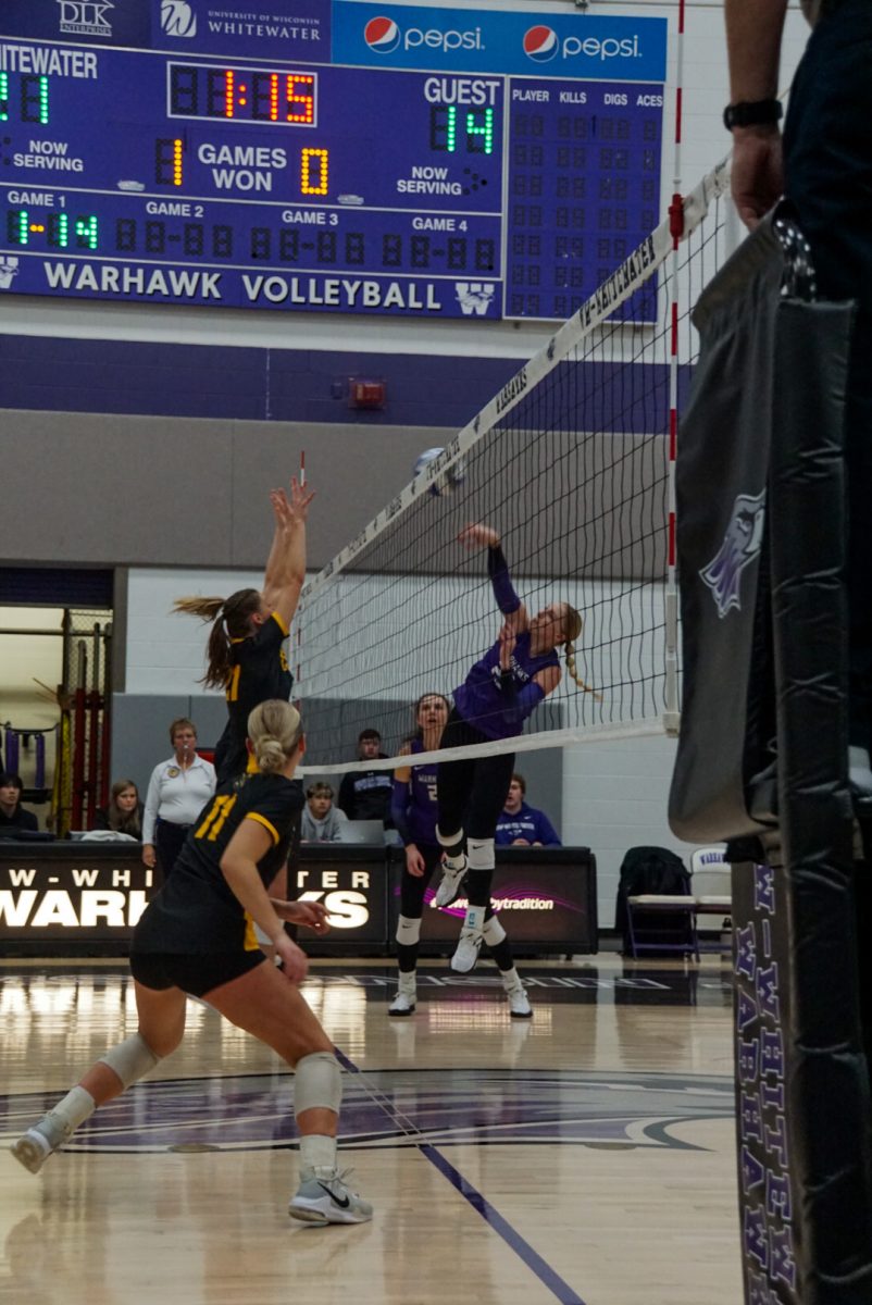 UW- Whitewaters number 23, Abbie Dix, hits the ball over the net for a point