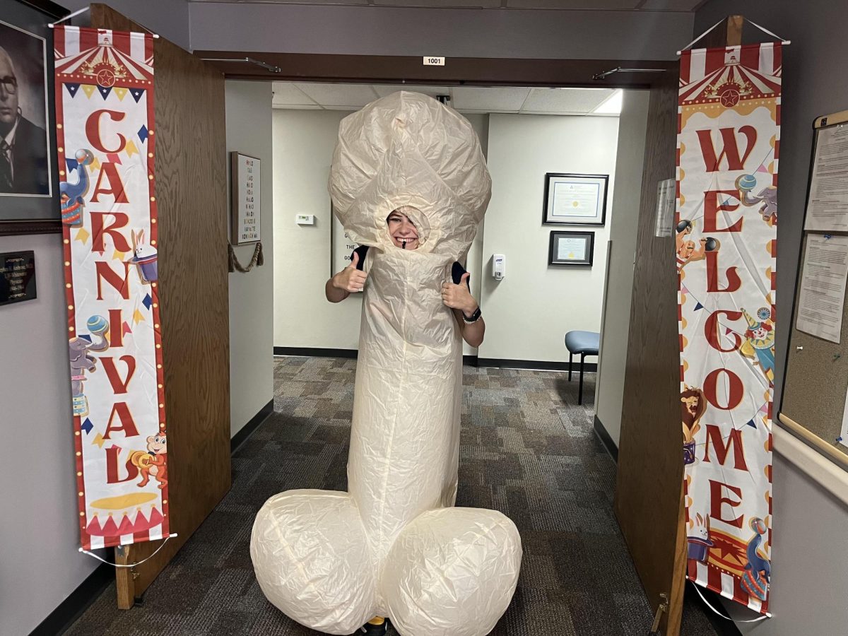 University Health and Counseling Services employee Peyton Boston welcomes students into the Sexual Carnival in the Ambrose Health Center on Oct. 4, 2023.