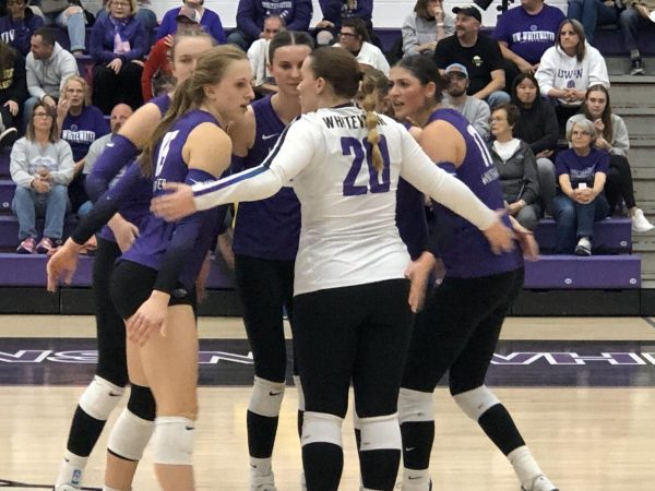 Libero Graduate Student Morgan Jensen (#20) leads a quick player huddle on the court for Whitewater.