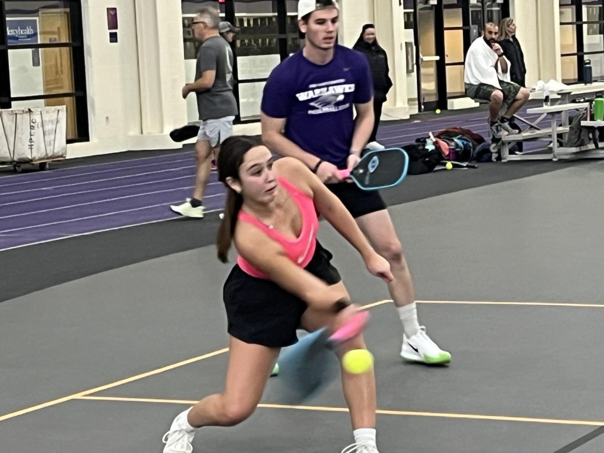 A player hits a groundstroke as she and her partner compete in a mixed doubles tournament inside the Kachel Fieldhouse in Whitewater, Nov. 11, 2023.