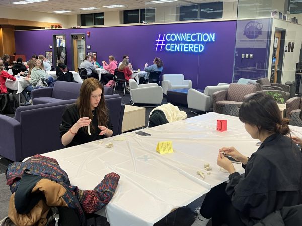 Students sit at tables as they shape their clay into their art pieces in the Warhawk Connection Center inside the UC Nov. 14, 2023.