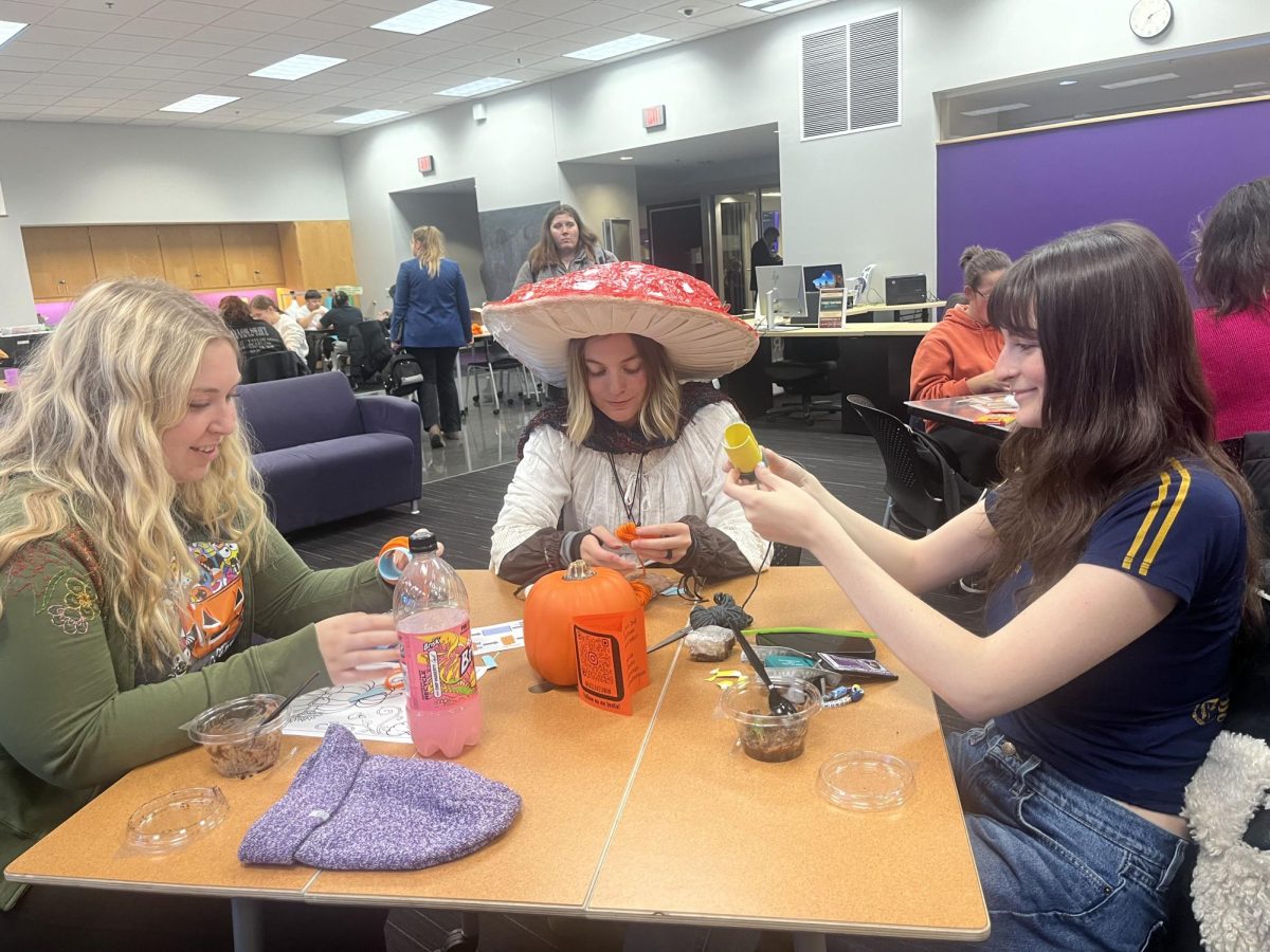 Students partake in activities such as coloring pages and pom pom decorating at the University’s Halloween Boo Bash.