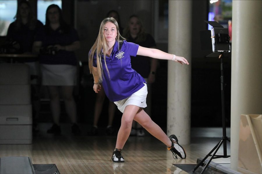 Kelly Whipple poses for an action shot on the bowling team’s media day inside Warhawk Alley.
