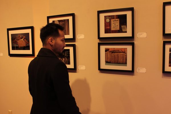 Derick Riese looking at Anthony Cerullis art