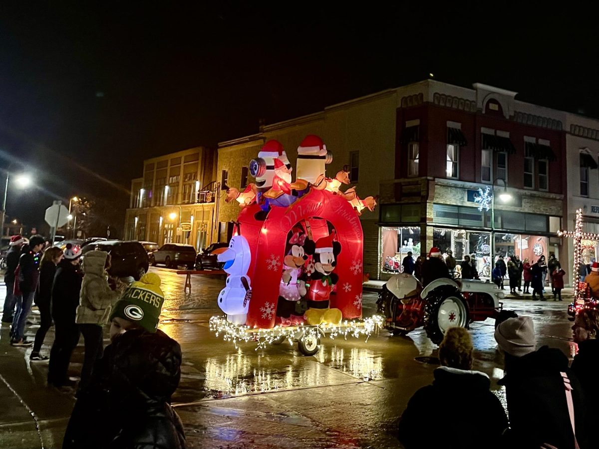The+community+gathered+on+Main+Street+on+Friday%2C+Dec.+1+to+celebrate+the+holiday+season+with+a+lighted+parade.+A+Disney+character+float+grabbed+the+attention+of+all+the+children+in+attendance+and+featured+Olaf%2C+Minnie%2C+Mickey%2C+and+Minions.+%0A