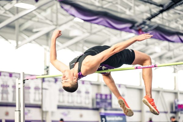 Spencer Steffen clears the bar during the high jump event.
