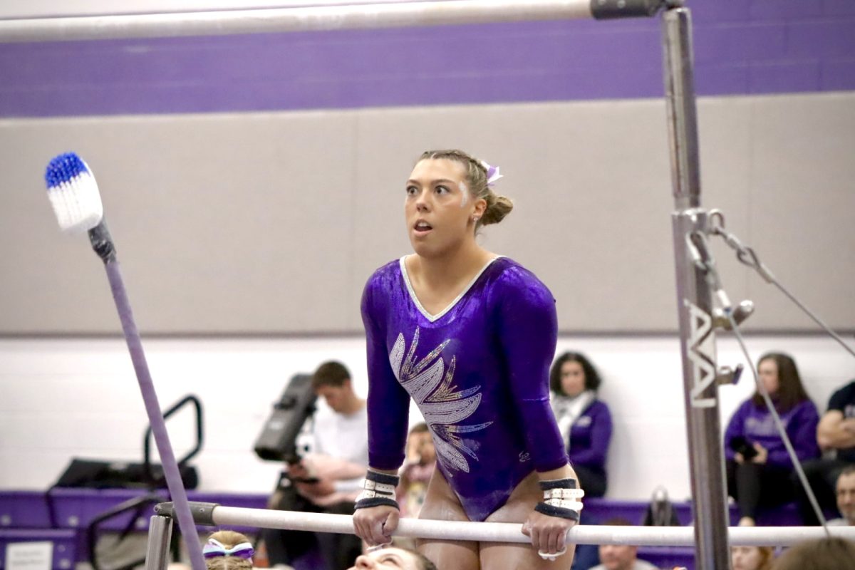 Junior Gracie Tally who performs vault, bars, and the beam takes to the bar and concentrates to land her jump successfully at the Gymnastics Tournament Saturday Feb 17, 2024 in the Williams Center. 
