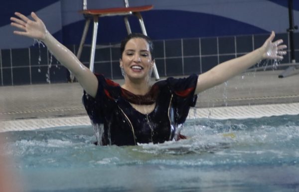 WTMJ New Anchor ,board member of the Special Olympics, and MC of the Polar Plunge Julia Fello emerges from the water smiling with her hands spread wide at the Whitewater Aquatic & Fitness Center Saturday afternoon March 9, 2024.
