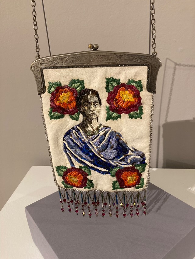 Hero/Shero series: Ode to Frida by Melanie Tallmadge Sainz. This piece was made using deerskin, porcupine quills, Czech glass cut-beads and glass bugle beads, Swarovski crystals, vintage Italian glass beads, vintage re-purposed silver purse clasp with chain handle. 