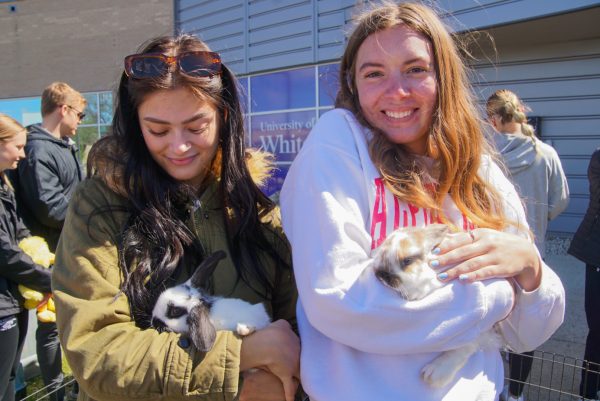 Students Rachel Warren (on the left) and Kylie Lang (on the right) cuddling up with the bunnies. 