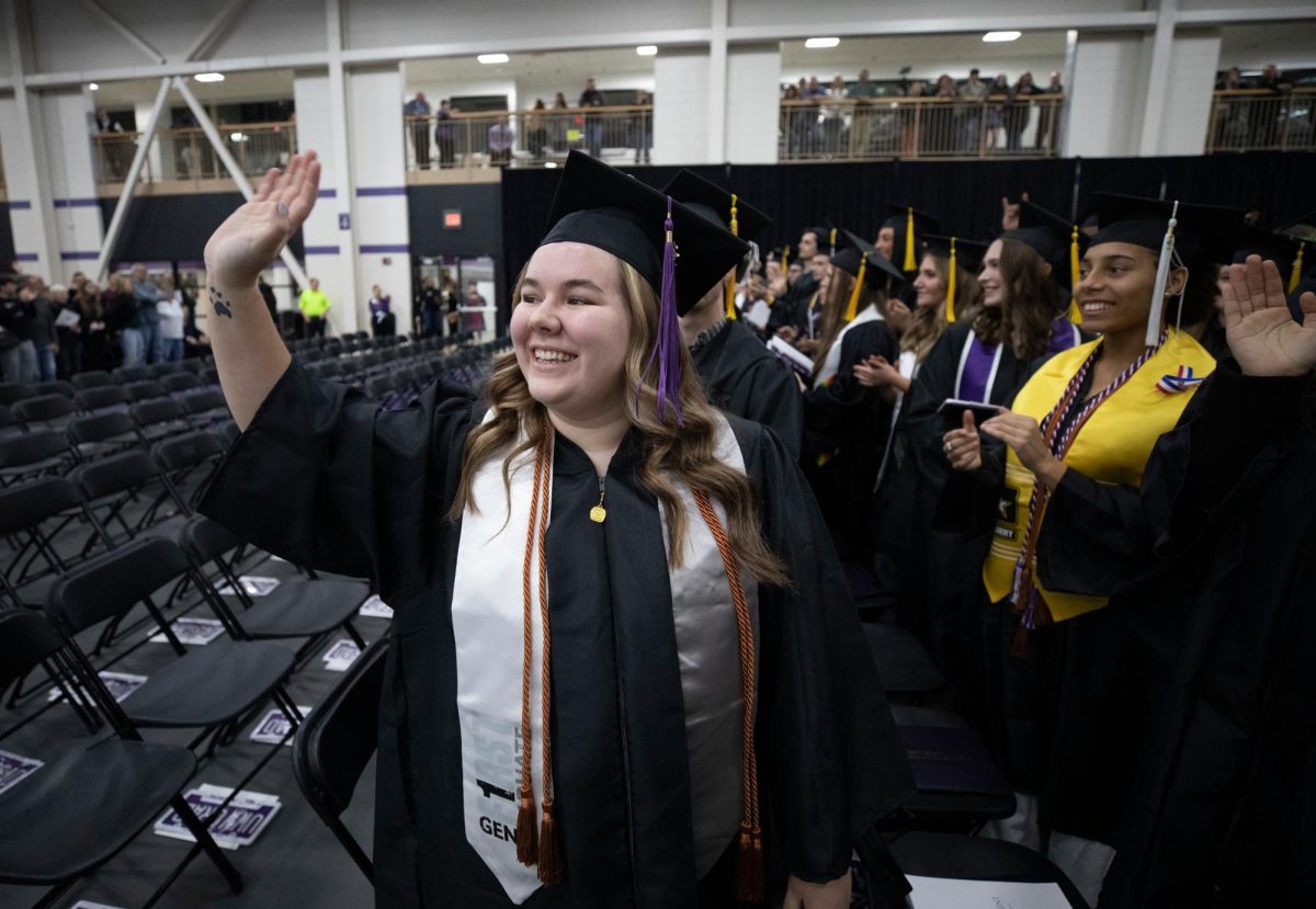 Natalie Van Acker of East Troy, Wisconsin, a criminology major, waves to the crowd as students thank their families and friends for supporting their high education journeys. UW-Whitewater celebrated the achievements of 620 graduates at the commencement ceremony held at Kachel Fieldhouse on Dec. 16, 2023.