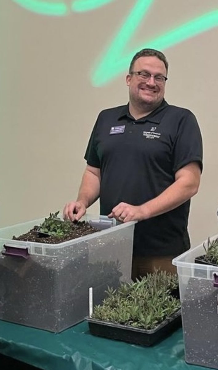Sustainability Director Wes Enterline helps students to hand out succulents for the UC Live collaboration with UWW-Sustainability, Tuesday evening, April 9, 2024.