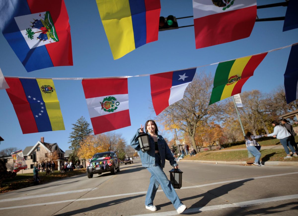 Montserrat Cuevas, a Spanish major from Whitewater, walks among the colorful flags carried by the Latinos Unidos student organization. A perfect fall day greeted the UW-Whitewater Homecoming Parade on Saturday, Oct. 29, 2022, as floats, student organizations and royalty made their way along Main Street and Prairie Street in Whitewater.