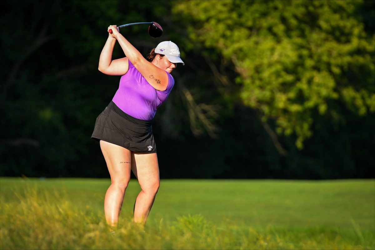 Fifth-year senior Haley Myers mid-swing, preparing to drive the ball down course.