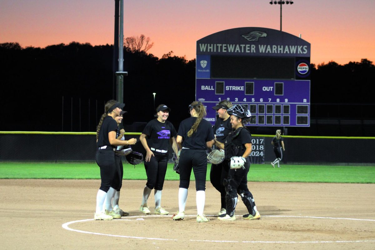 UW-Whitewater softball celebrates during their first action under their new lighting system at Van Steenderen Softball Complex last Thursday, Sept. 26. On top of regular season games, the lights provide a greater opportunity for the team to host WIAC/NCAA tournament games later in the evening.