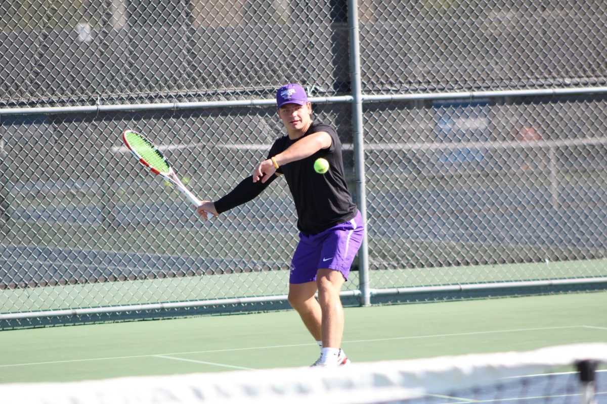 Payton Adkisson warms up before his match with his opponent at the Warhawk Fall Invite in Whitewater, WI, Sept. 7, 2024