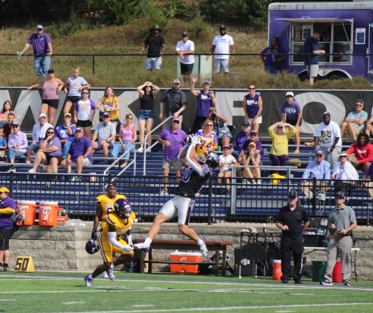 Sophomore Devin Magli (#20) one of the defensive back for UW-intercepting a pass against the University of Mary Hardin-Baylor offense team.   