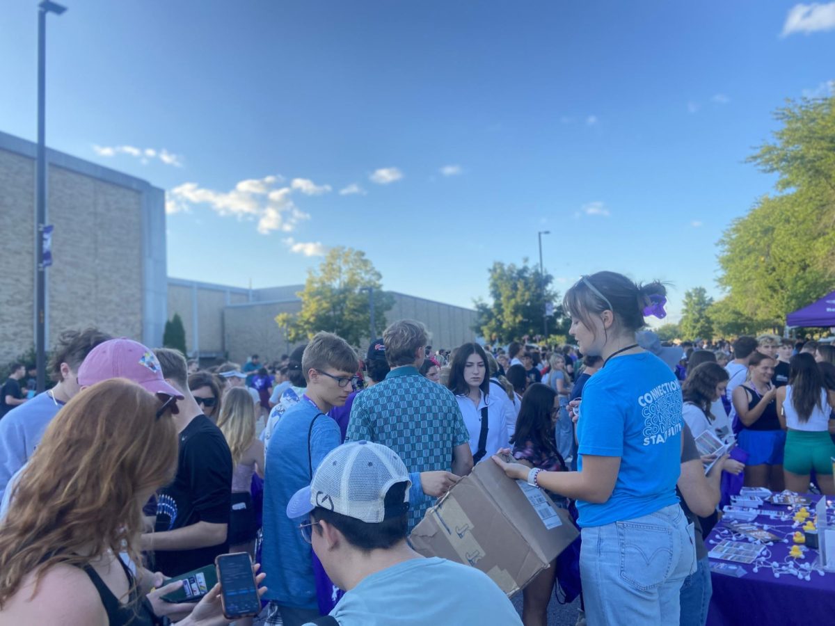 Incoming students gather around the a student handing out rubber ducks to people who follow the University Center Instagram during Hawk Fest, Sept. 1, 2024.