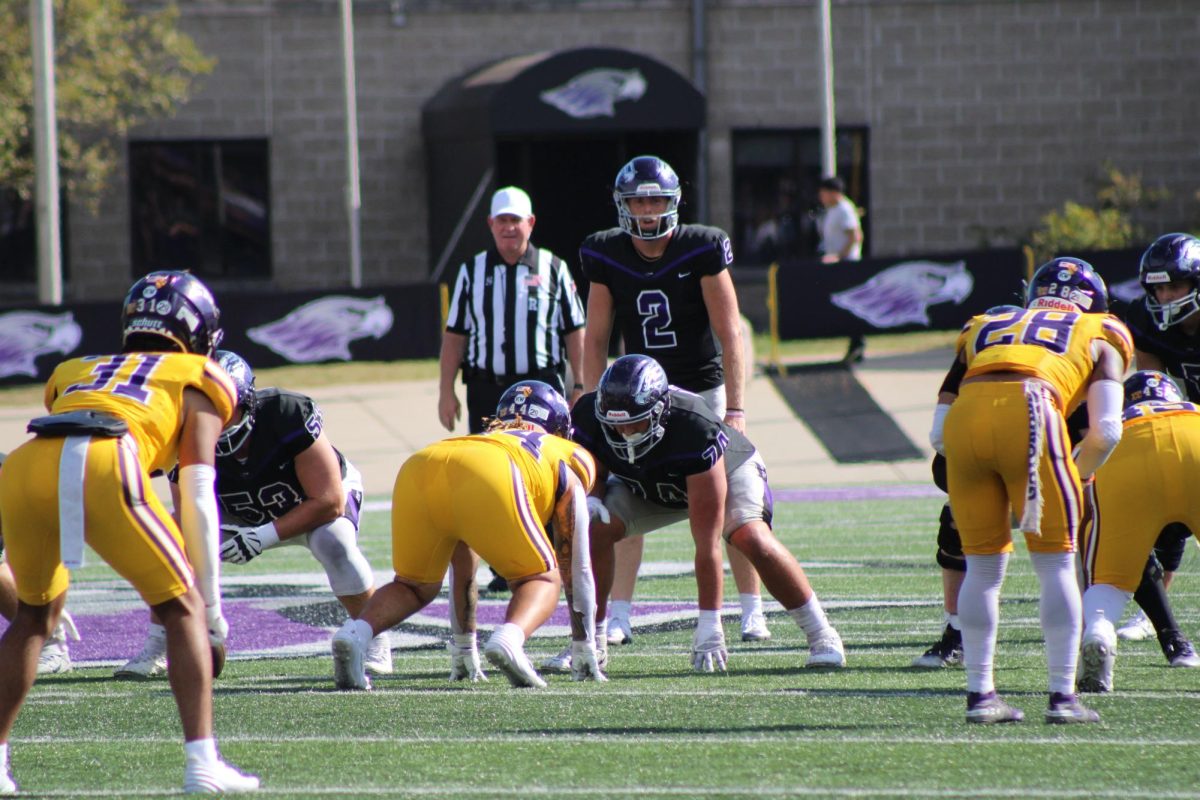  UW-Whitewater’s football team lines up on offense as quarterback Jackson Chryst yells a play against University of Mary Hardin-Baylor at Whitewater’s Perkins Stadium Sept. 21 2024.
