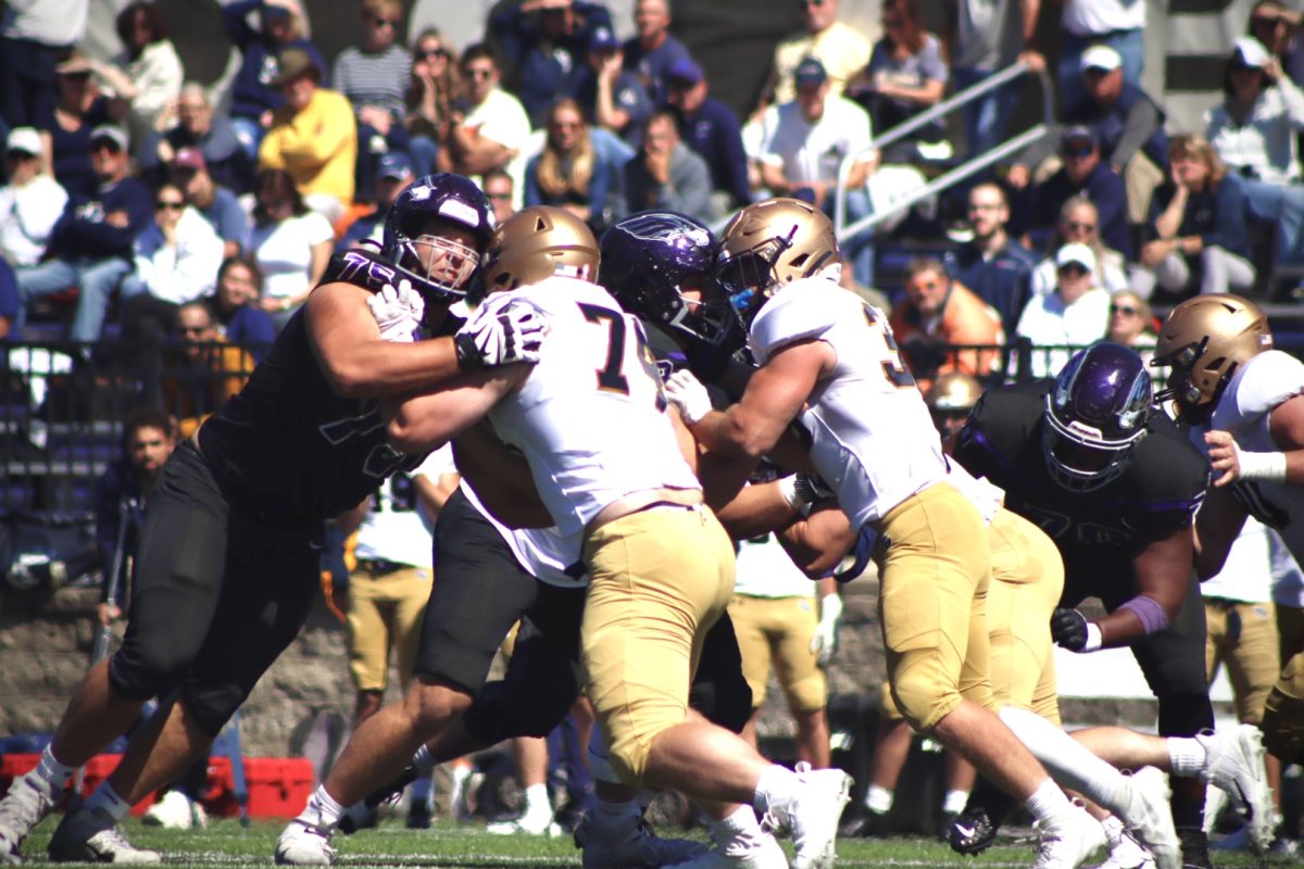 UW-Whitewater and John Carroll players fighting to gain ground in Whitewater, WI, Sept. 7, 2024