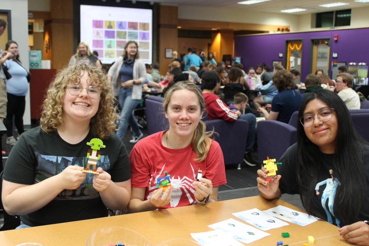 (left to right) Olivia Gross (Sophomore), Belle Hafeman (Junior), Gabby Zavaleta (Freshman) attends the University Center’s Lego Night for a night full of building blocks, and hanging out with friends in the Warhawk Connection Center Sept. 25, 2024. 
