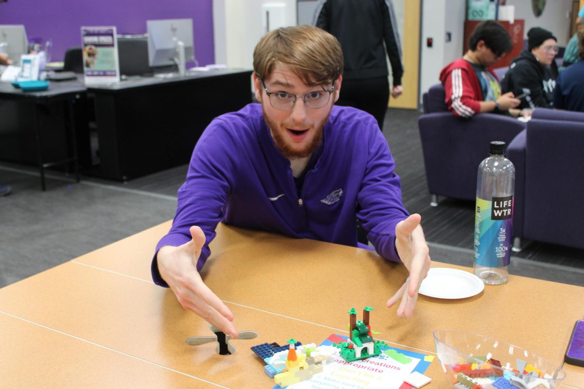 Dylan Mathiot (Senior) proudly showing off the Lego sets he built in the Warhawk Connection Center for Lego Night Sept.25, 2024. 