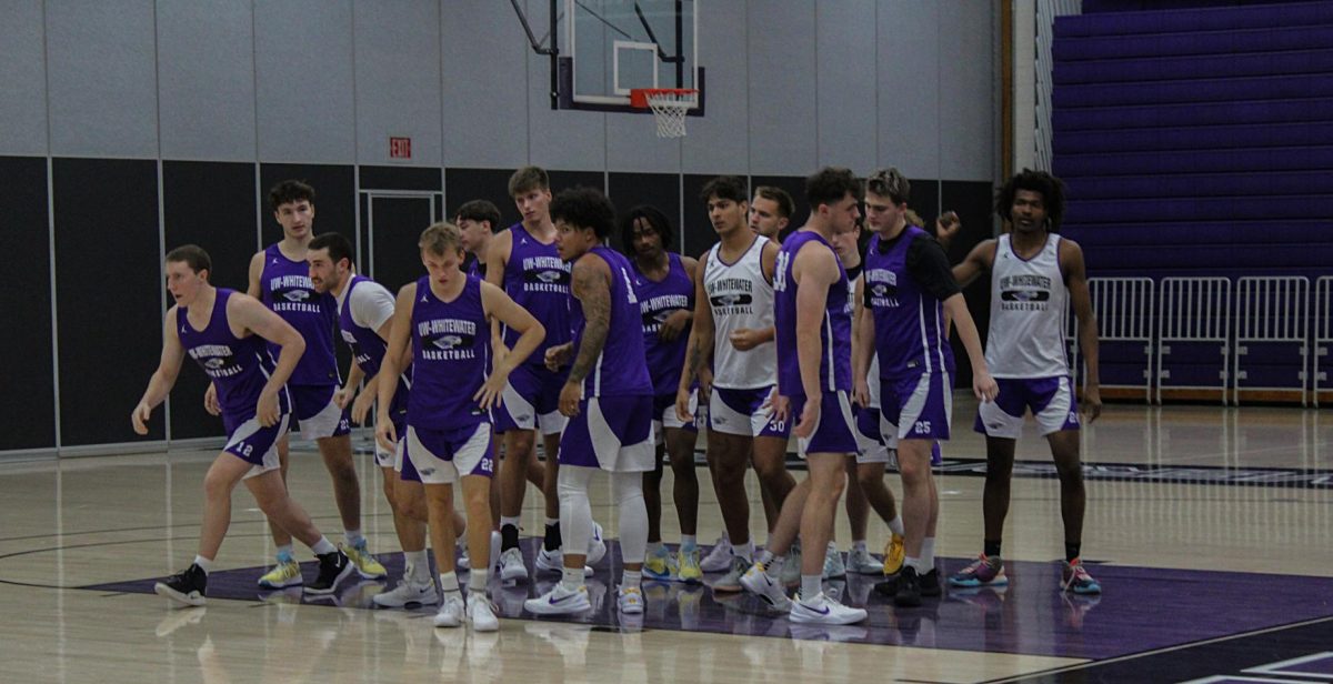  The UW-Whitewater men’s basketball team huddles together during a team practice.
