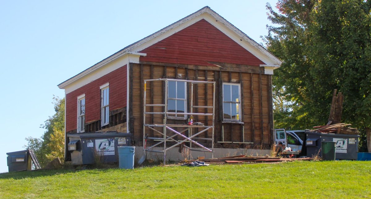 The Little Red School House being stripped of its siding Wednesday, Oct. 9, 2024. The single room school has stood at UW-Whitewater since 1966 after it was donated to the university. It was originally constructed in Milwaukee in 1866. 