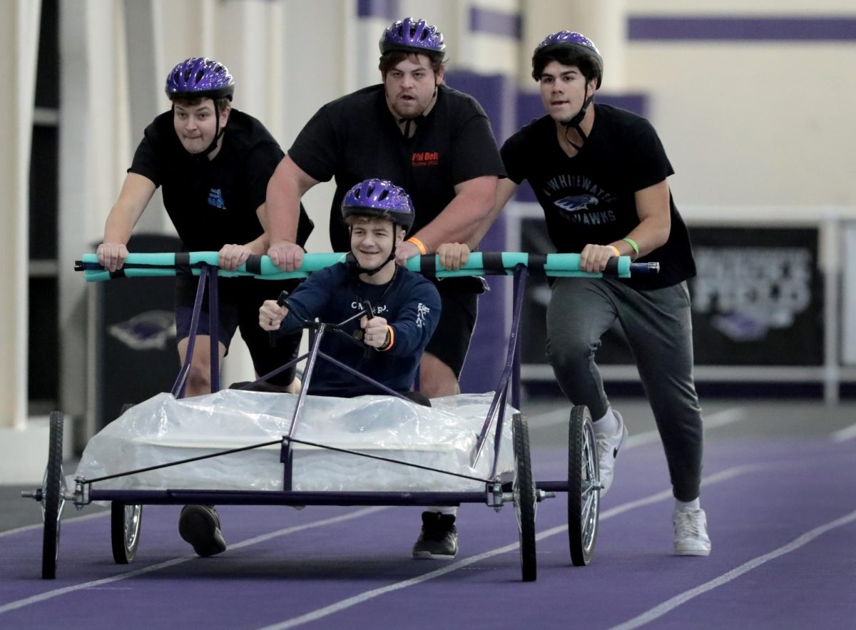 The Phi Delta Theta team competes in bed racing. From left, Jayden Williams, an accounting major from Evansville, Bobby Mann, seated, a general management major from Wilmington, Illinois, Aaron Schultz, a marketing major from New London and Dimitri Ioannou, a general management major from Clarendon Hills, Illinois. UW-Whitewater student organizations and the Greek Community converged at Kachel Fieldhouse on Friday, Oct. 28, 2022, for some friendly competitions as part of Homecoming Week.