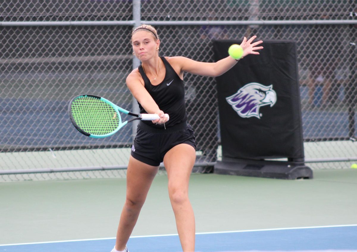 Freshman Abby Weaver slices a forehand in her No. 4 singles tennis match vs UW-La Crosse at the Warhawk Outdoor Tennis Complex, Friday, August 30, 2024.