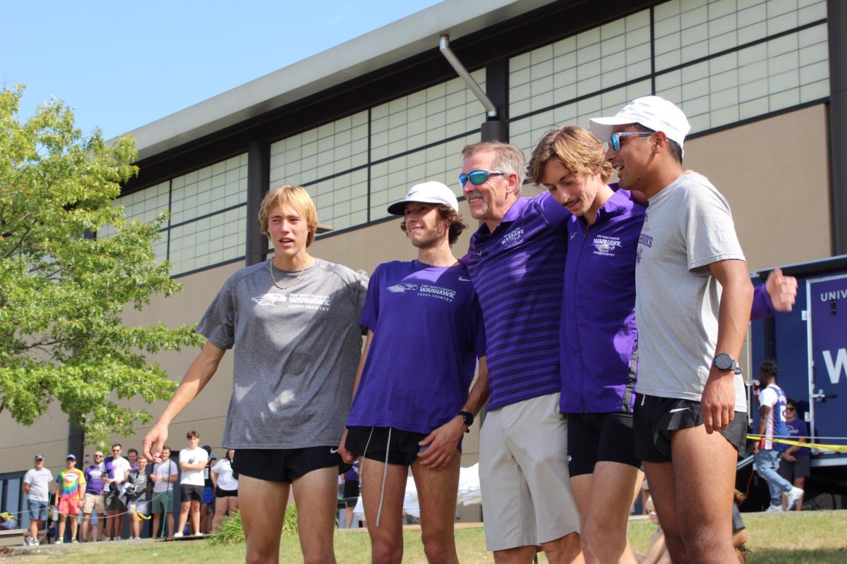 Cross country seniors pose with head coach Jeff Miller. From left to right: Chris Allen, Gunner Schlender, Jeff Miller, Christian Patzka, Will MacCudden.
