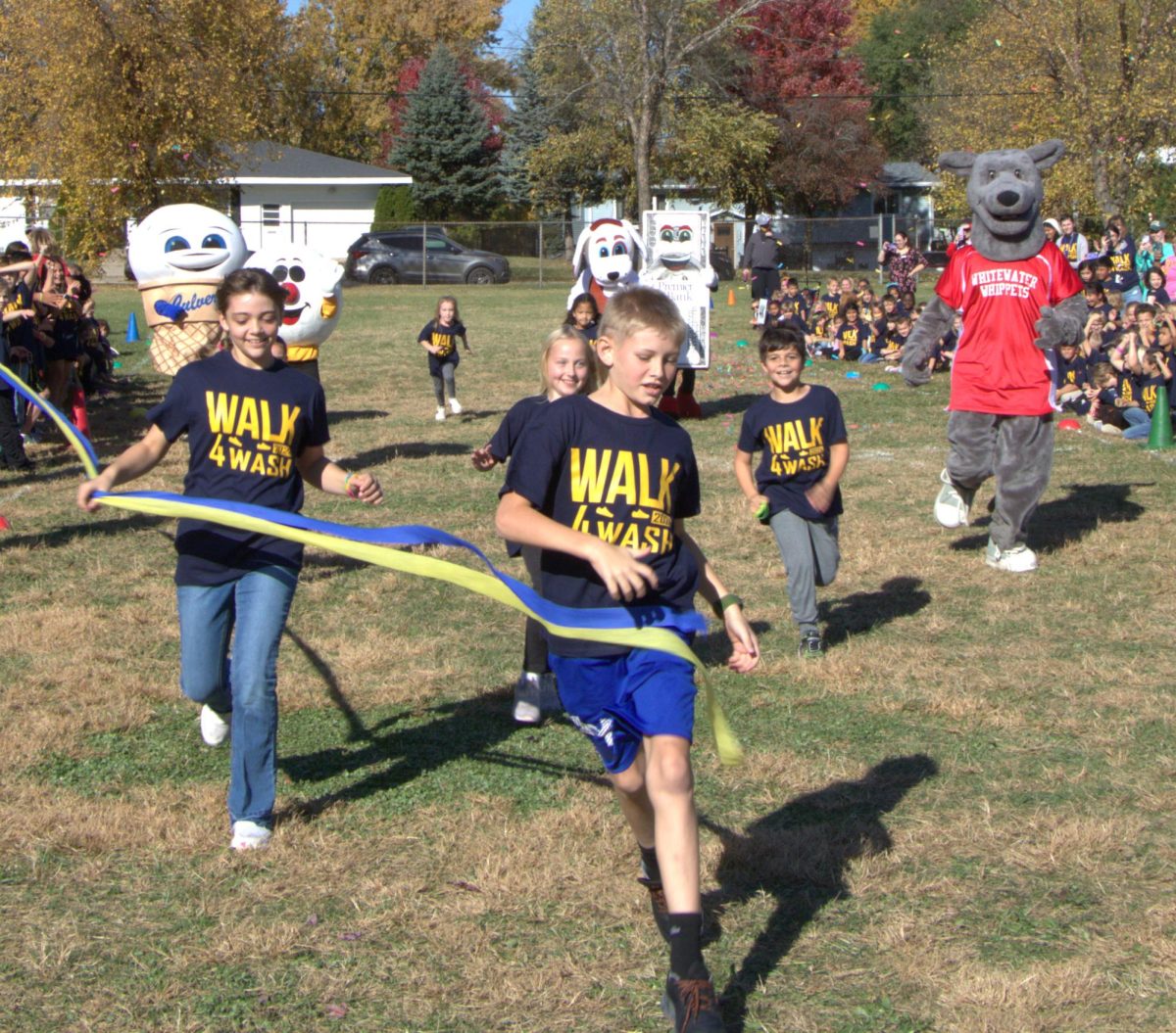 Top fundraisers from each class crossing the finish line in the race against mascots during “Walk 4 Washington.