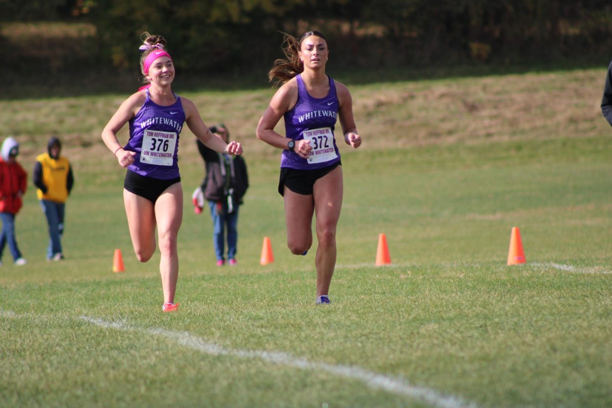 UW-Whitewater Women’s Cross Country runners, pictured, from left, Kayla Fogarty and Mollie Bennett run down the home stretch at the Warhawk Open on Friday, Oct. 25 in Whitewater.
