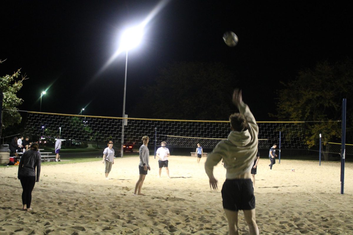 Student starting the game by setting volleyball to the other team during sand volleyball at the sand volleyball courts Oct. 1, 2024
