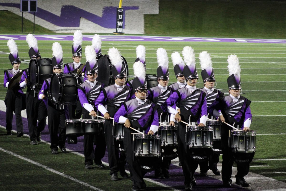 UW-Whitewater percussion marching beans heading off the field after performing the State Marching Band Championship in Perkins Stadium Oct. 19, 2024. 