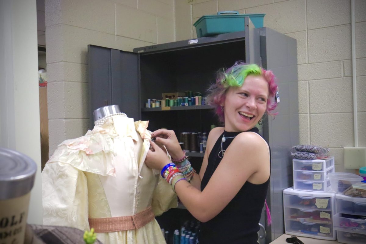 Student and Costume shop worker Jane Rhine smiles with her co-workers while she works on one of the dresses for Lady Windermere’s Fan, Thursday afternoon, October 3, 2024.