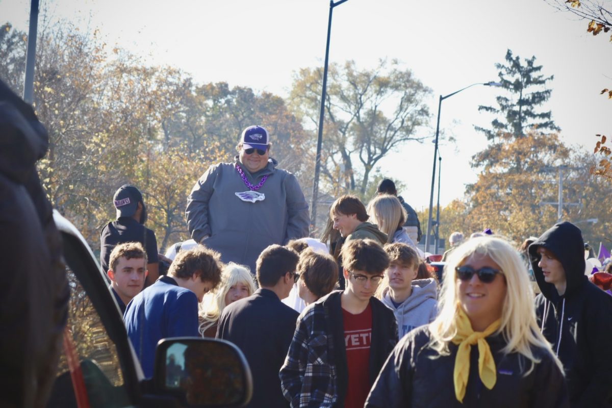 Whitewater Student Government President Douglas Bradley III smiles with members of his organization just before his float enters the Homecoming parade in a sea of people, Saturday morning, November 2, 2024.