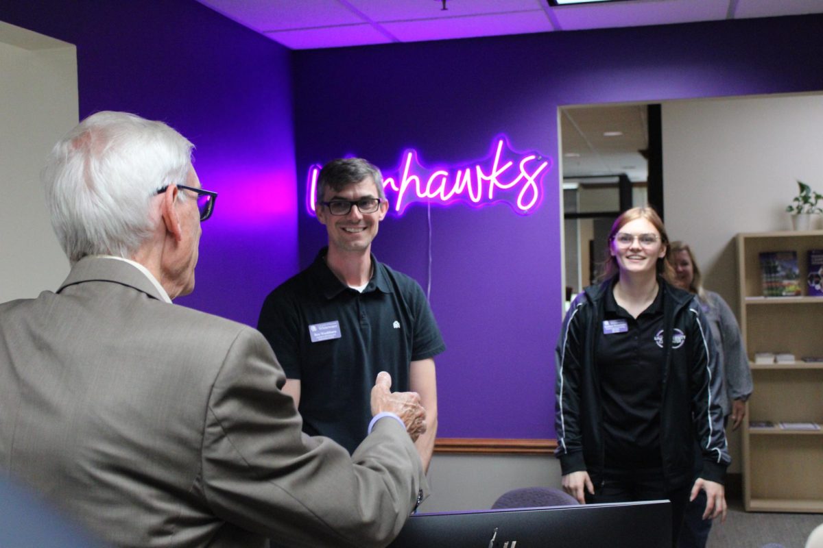 Wisconsin Gov. Tony Evers meets with Graduate Assistant Ben Washburn and Student Services Training Specialist Esther Frontuto in the One Stop office on Sept. 18, 2024.